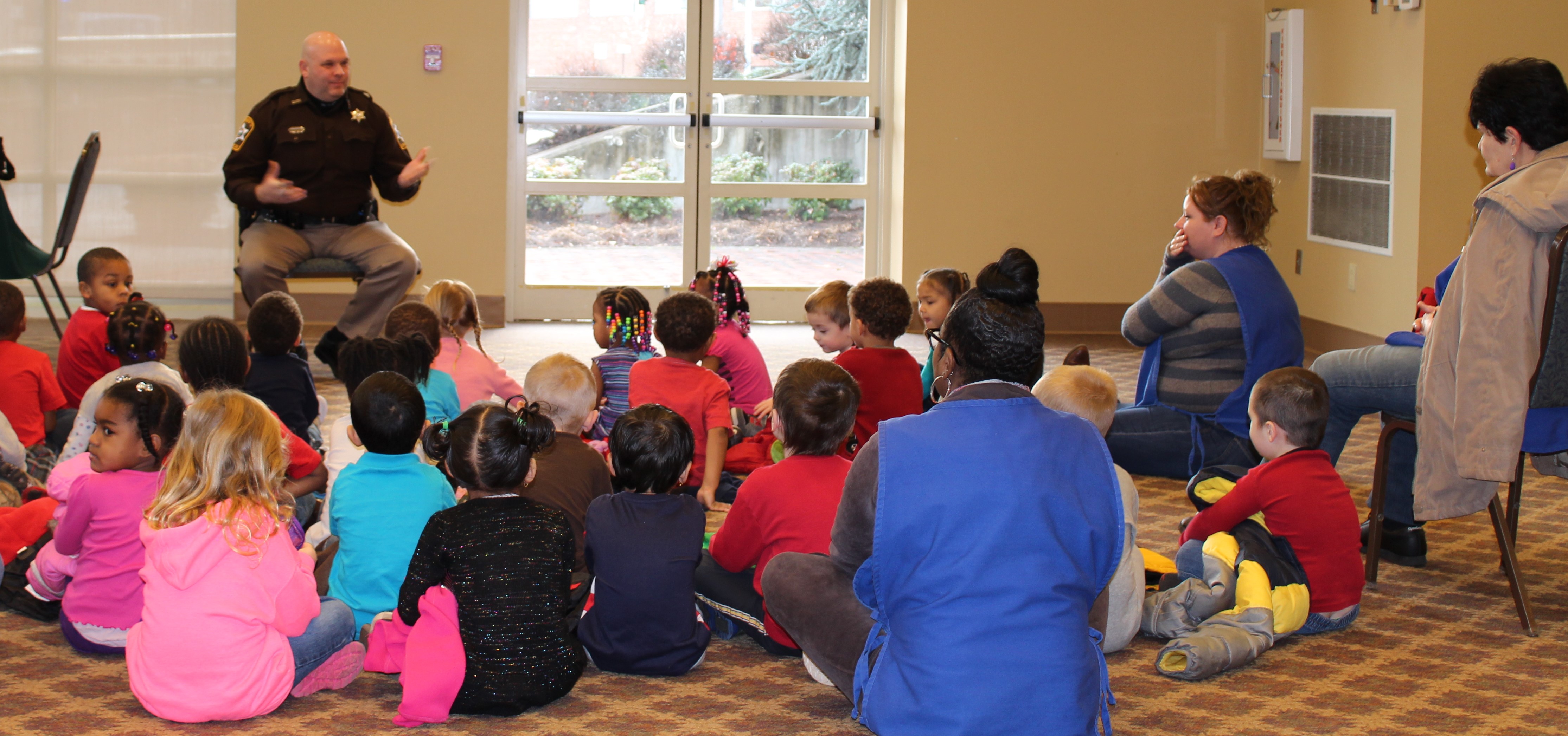 Major Steve Garber speaking with children.