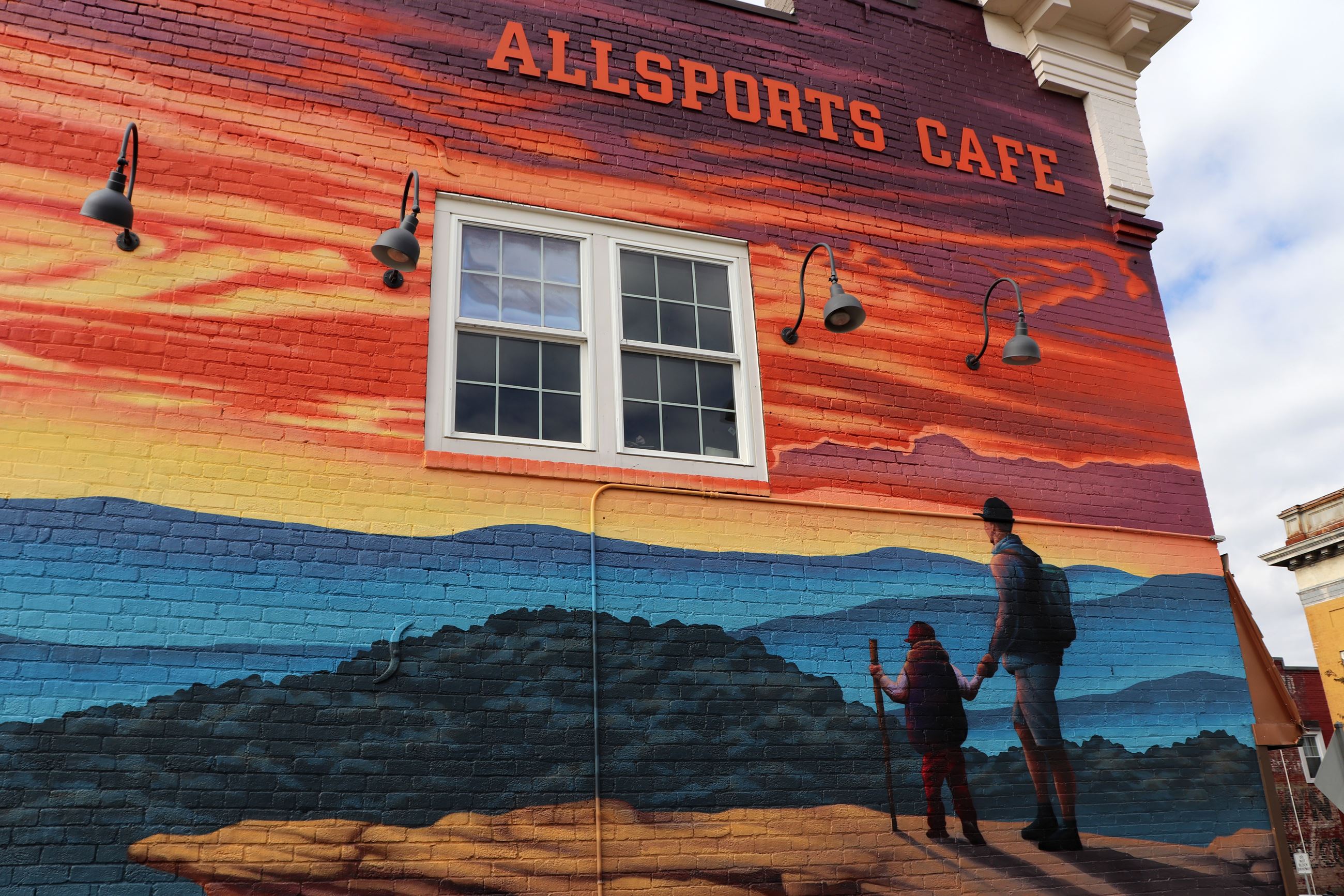 Mural in downtown Salem of a man and son standing on a mountain top