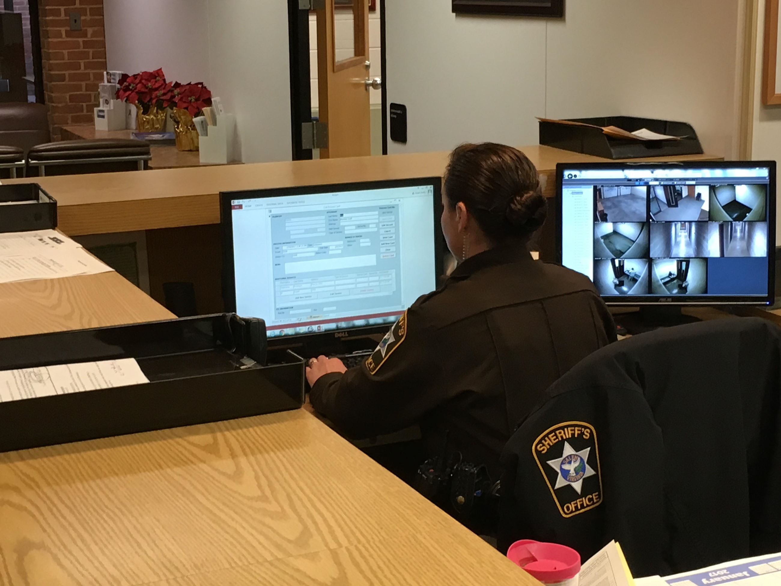 Sheriff working on computer in office.
